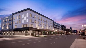 A modern hotel with a flat facade, multiple windows, and a sign reading "Courtyard." - Courtyard by Marriott Lansing Downtown (Lansing)