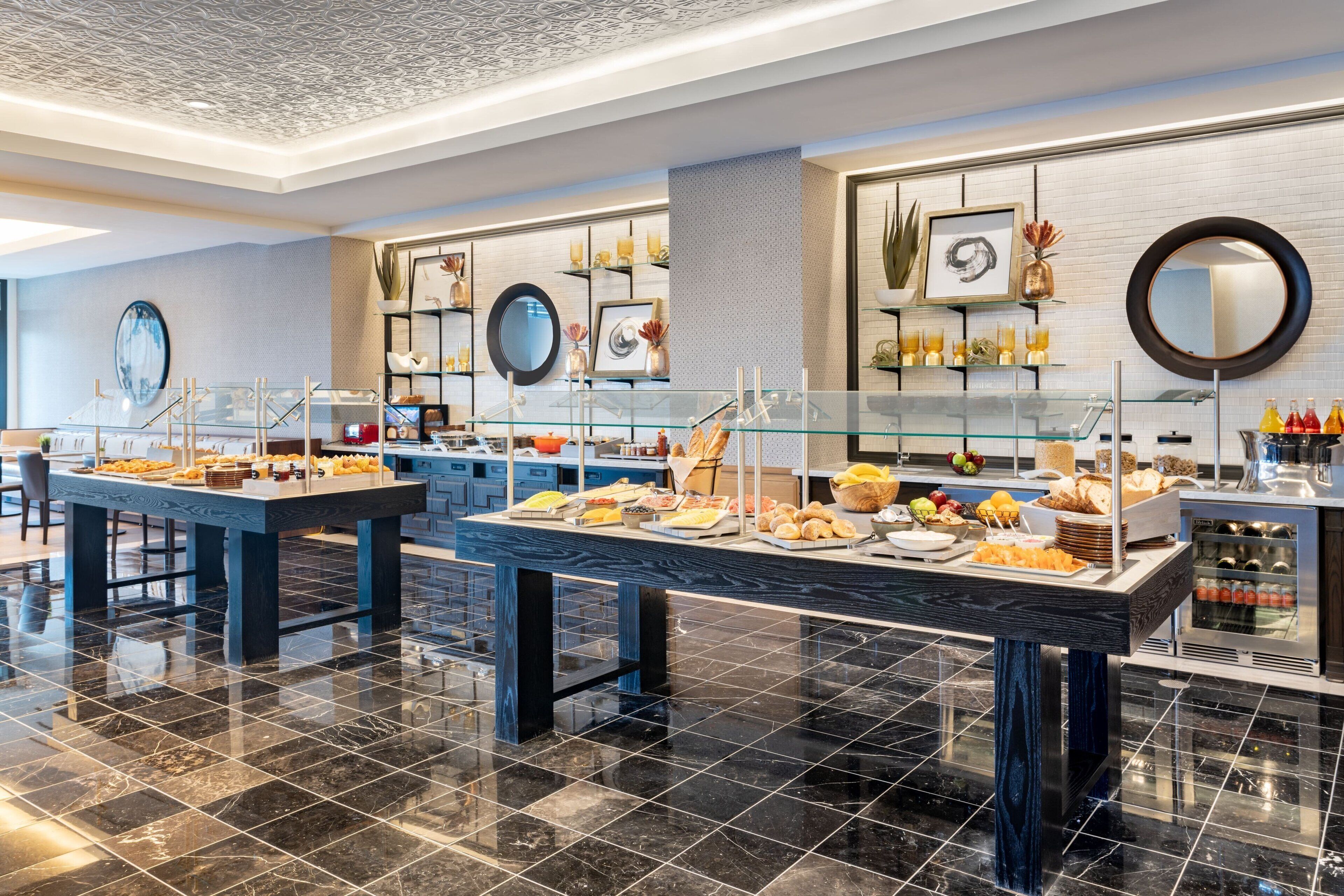 A buffet area with various food items and a modern interior design.