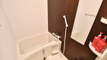 A modern bathroom with a bathtub, a shower, and a mirror.