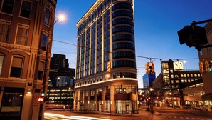 A multi-story hotel with a curved facade, large windows, and a prominent entrance. - Residence Inn by Marriott Grand Rapids Downtown (Grand Rapids)