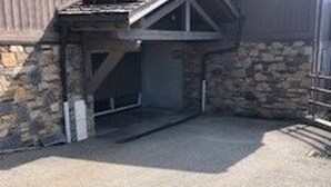 A building with a stone exterior and a metal door.