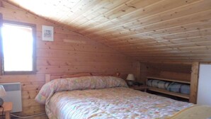 A cozy wooden cabin bedroom with a bed, a desk, and a window. - Duplex for 6 with Garage, Near Slopes in Crest-Voland (Crest-Voland)