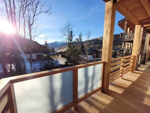 A wooden deck with a view of a mountainous landscape.