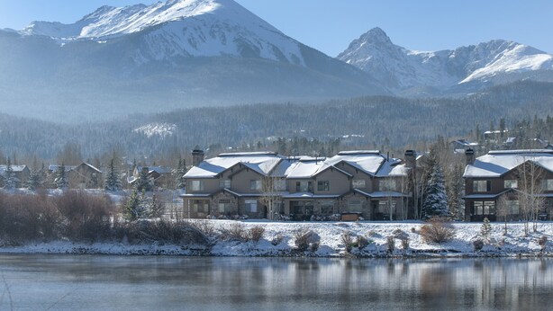 A residential area with snow-covered houses and mountains in the background. - Private Lakefront Luxury in the heart of Ski Country, Mountain Views (Silverthorne)