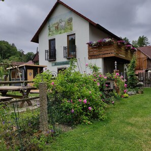 A two-story building with a balcony, a satellite dish, and a sign reading 'Feriendorf.'