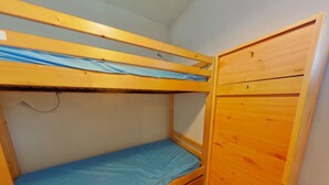A bunk bed with a wooden wardrobe beside it. - 2-Room Apt - 5 people, Les Saisies, Pets allowed (Les Saisies)