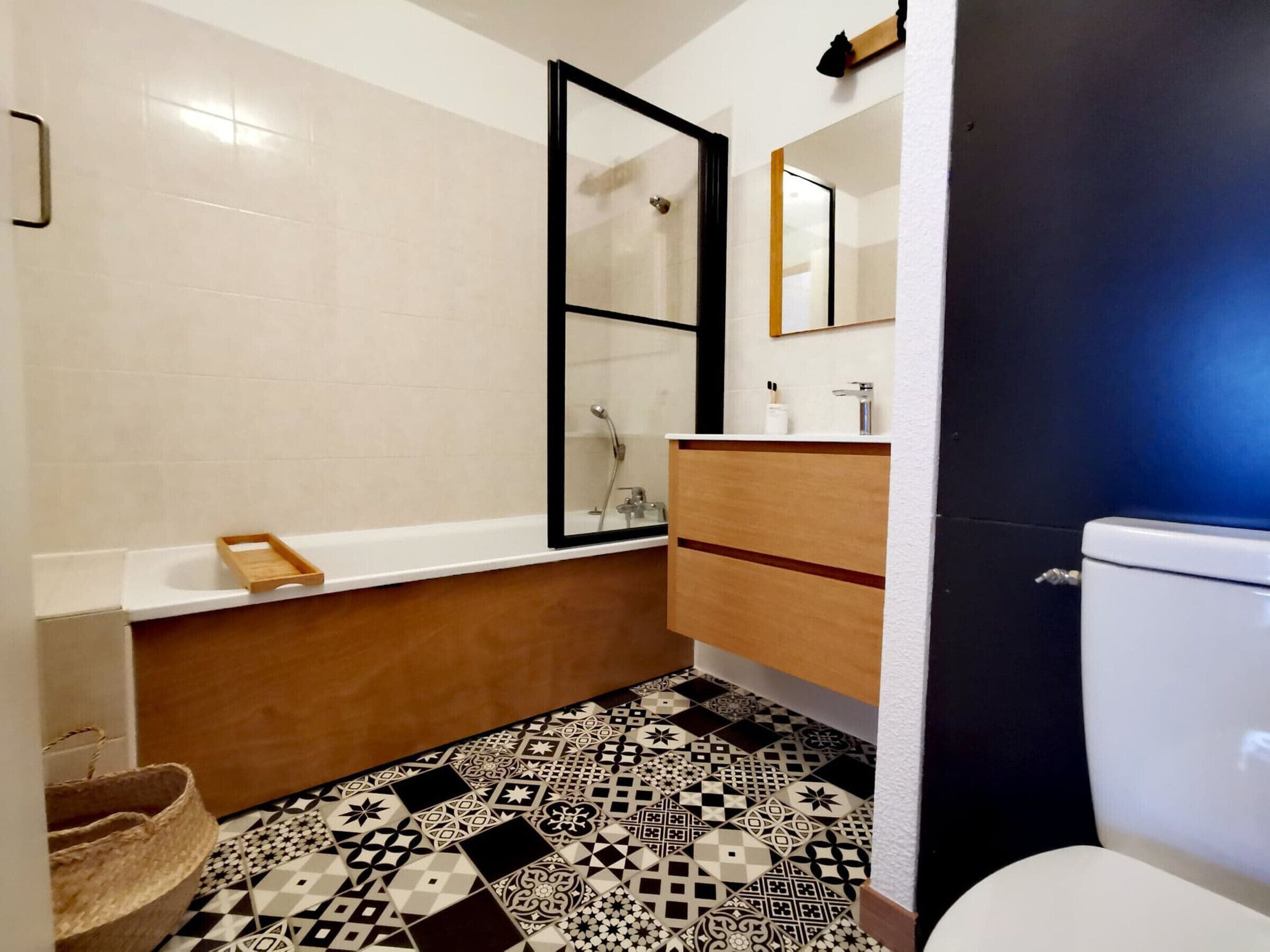 A bathroom with a bathtub, a toilet, and a sink.