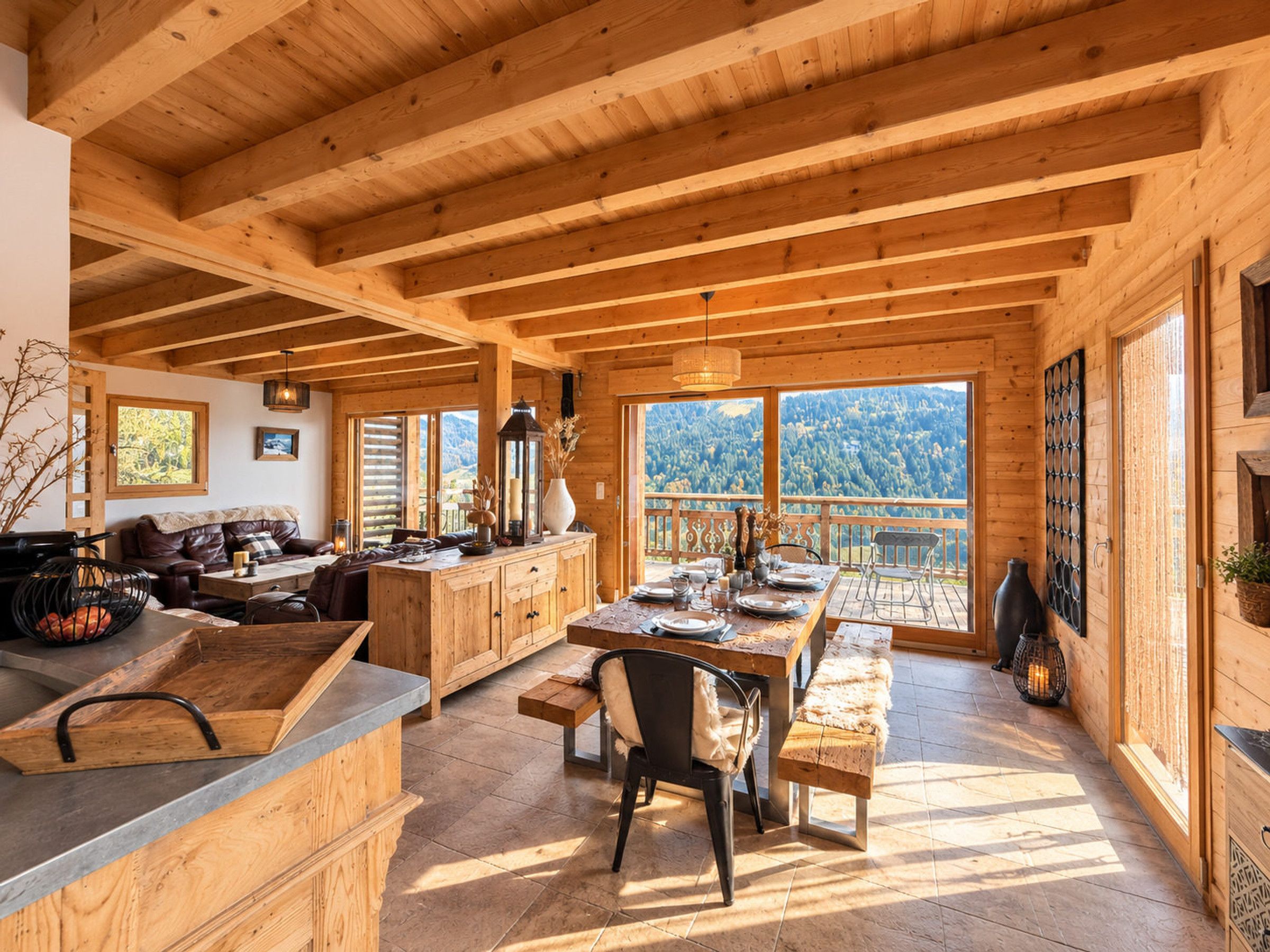 A wooden interior with a dining area, kitchen, and seating space.
