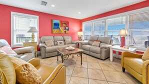 A living room with two sofas, a coffee table, and a side table with a lamp.