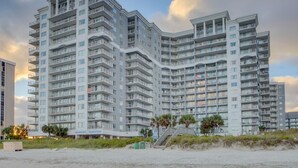 A high-rise hotel with multiple balconies and a beachside location. - Oceanfront family fun, multiple pools, great views + Free Attraction Tickets! (Myrtle Beach)