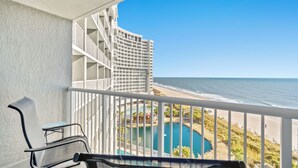 A balcony with a view of the ocean and a pool area. - Oceanfront family fun, multiple pools, great views + Free Attraction Tickets! (Myrtle Beach)