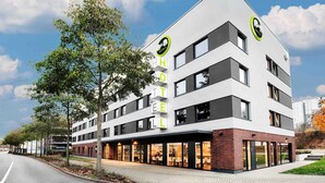 A modern hotel with a flat roof, multiple floors, and a prominent sign. - B&B Hotel Kaiserslautern (Kaiserslautern)