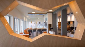 A modern dining area with a central table, chairs, and pendant lighting. - B&B Hotel Kiel-Wissenschaftspark (Kiel)
