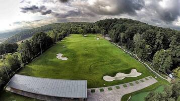 Enjoy a round of golf on our meticulously maintained course, surrounded by lush forest and a picturesque clubhouse.
