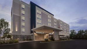Un hotel moderno con techo plano, ventanas grandes y una bandera estadounidense.