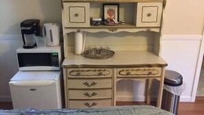 A compact kitchenette with a coffee maker, microwave, and small refrigerator. - Spacious room with private entrance near Bidwell Park! (Chico)