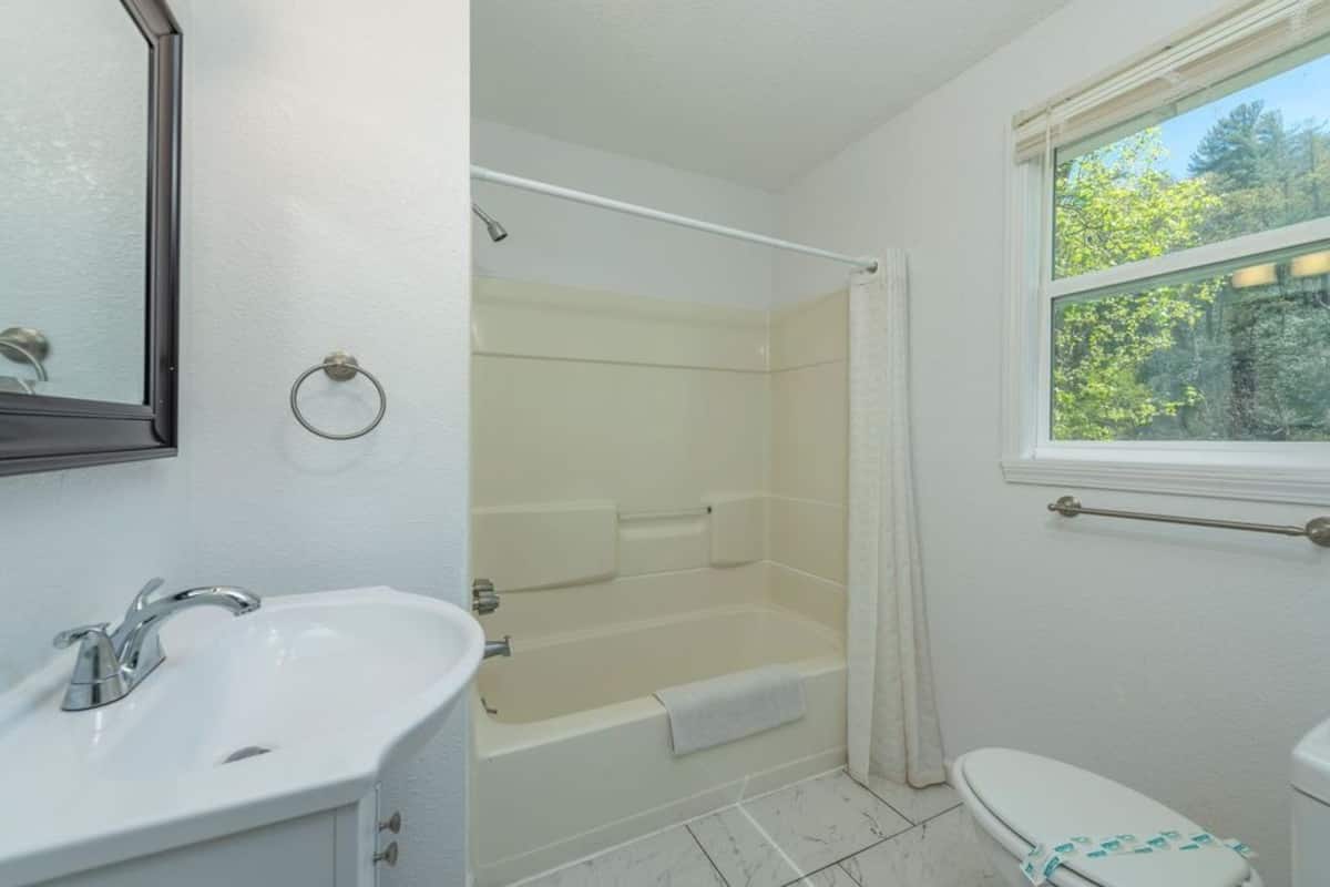 A bathroom with a sink, a bathtub, and a toilet.