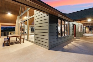 Relax in a tranquil setting with a covered outdoor area and wooden deck.