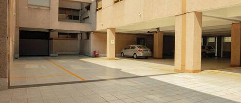 A multi-level parking garage with a car parked in one of the spaces.