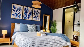 A bedroom with a bed, a nightstand, a lamp, a mirror, and wall art. - 3 Level Luxe Penthouse • 7 Real Beds • Mountain Views & Balcony • Zona T (Bogota)