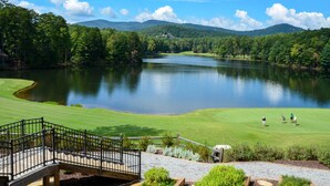 A golf course with a lake, surrounded by trees and hills. - Luxe Big Canoe Resort Home w/ 3 Decks & Mtn Views! (Jasper)