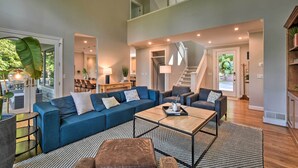 A spacious living room with a sectional sofa, a coffee table, and a staircase leading to an upper level. - Luxe Big Canoe Resort Home w/ 3 Decks & Mtn Views! (Jasper)
