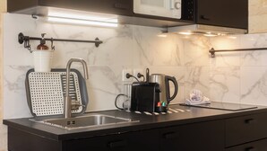 Una cocina moderna equipada con microondas, hervidor de agua y cafetera.