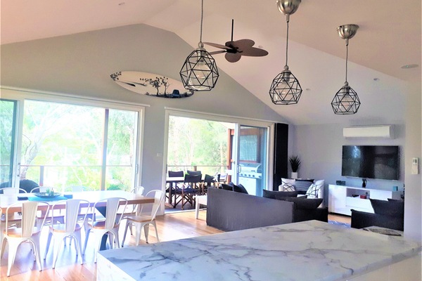 Looking from kitchen through the dinning and lounge rooms to the deck