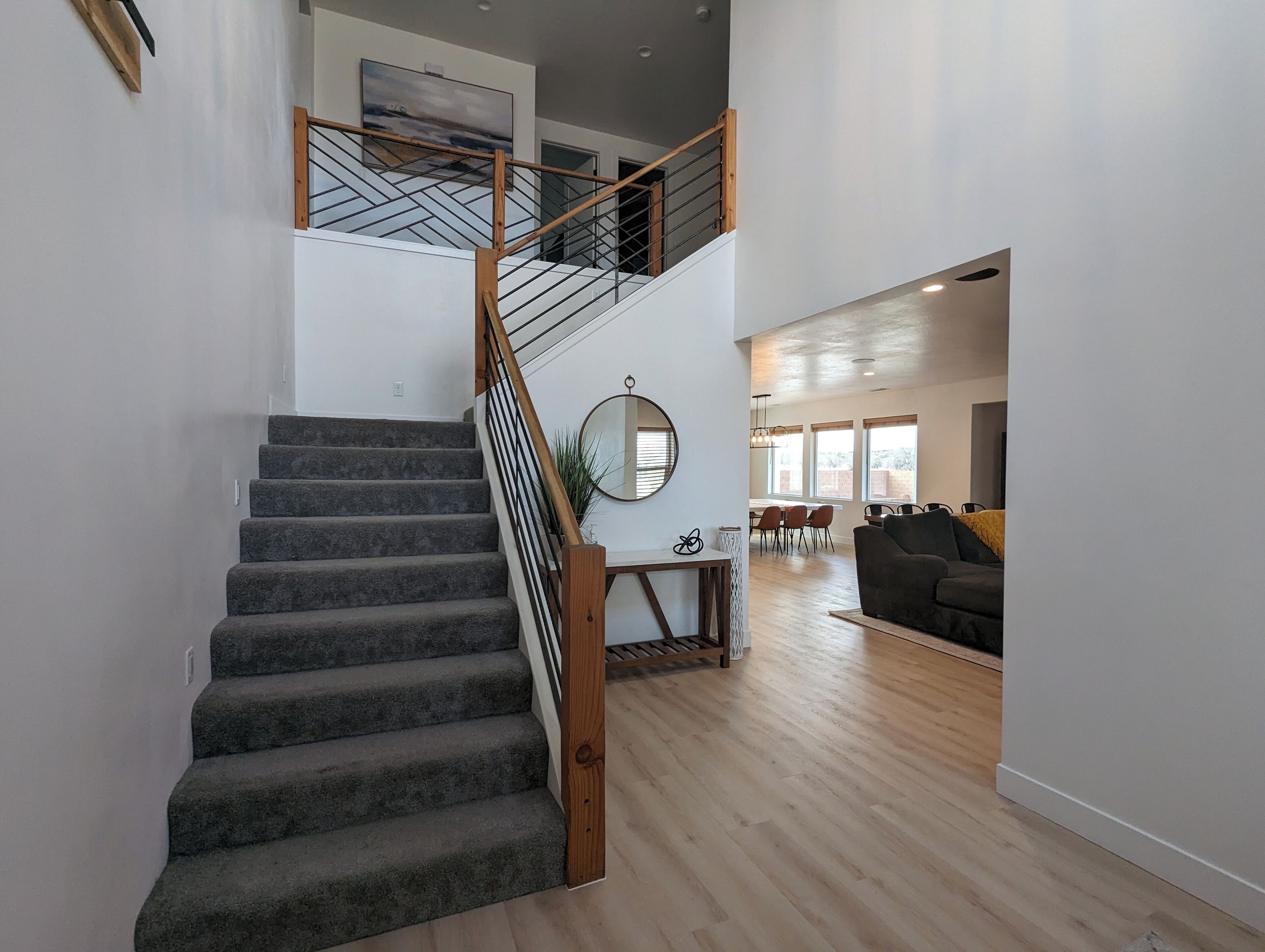 A staircase with a wooden railing leading to an upper level.