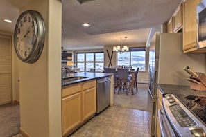 Enjoy cooking in this kitchen with a central island, oven, and ample counter space, offering a view of the surrounding landscape.
