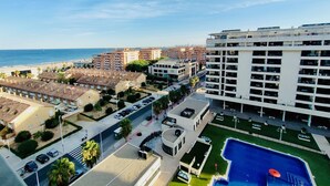 A high-rise hotel with multiple balconies, a swimming pool, and a view of the beach and ocean. - NON STRESS Duplex Penthouse with SEA views (Alboraya)