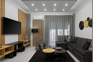 Relax in the living room with a sofa, flat-screen TV, and cozy seating area.