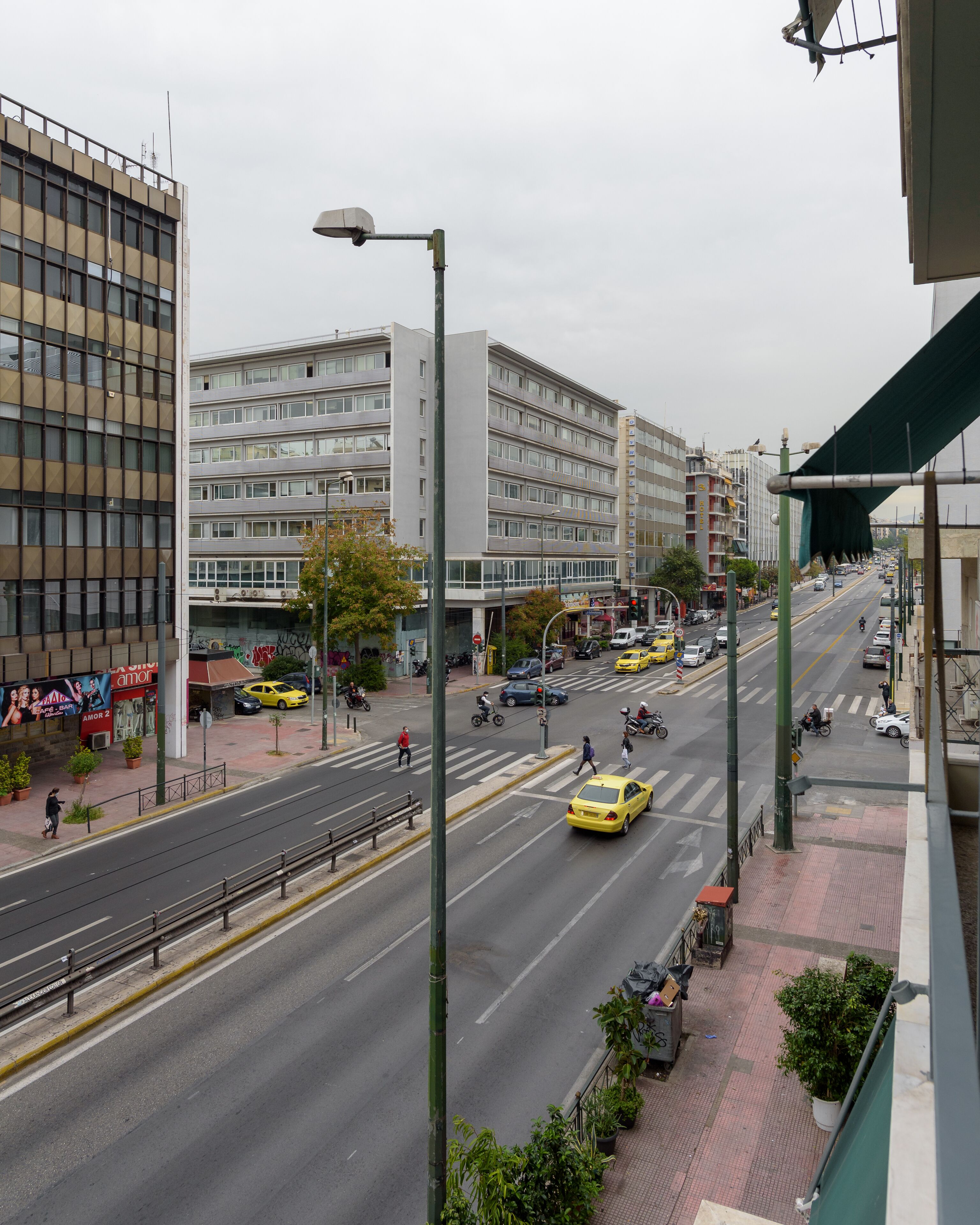 A multi-story building with a modern architectural design, featuring a mix of glass and concrete facades.