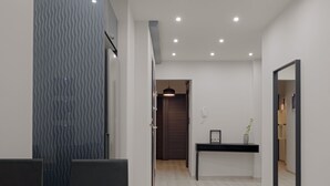 A modern interior with a wooden table, dark chairs, a patterned wall, a dark console table, and a mirror. - Acropolis Deluxe Apartment (Athens)