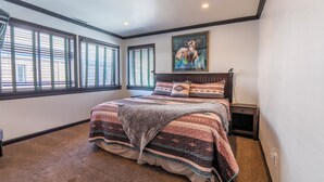 A bedroom with a large bed, a painting of a cow, and a window with blinds. - Edgewater #20 - 2 BD/2 BTH (June Lake)