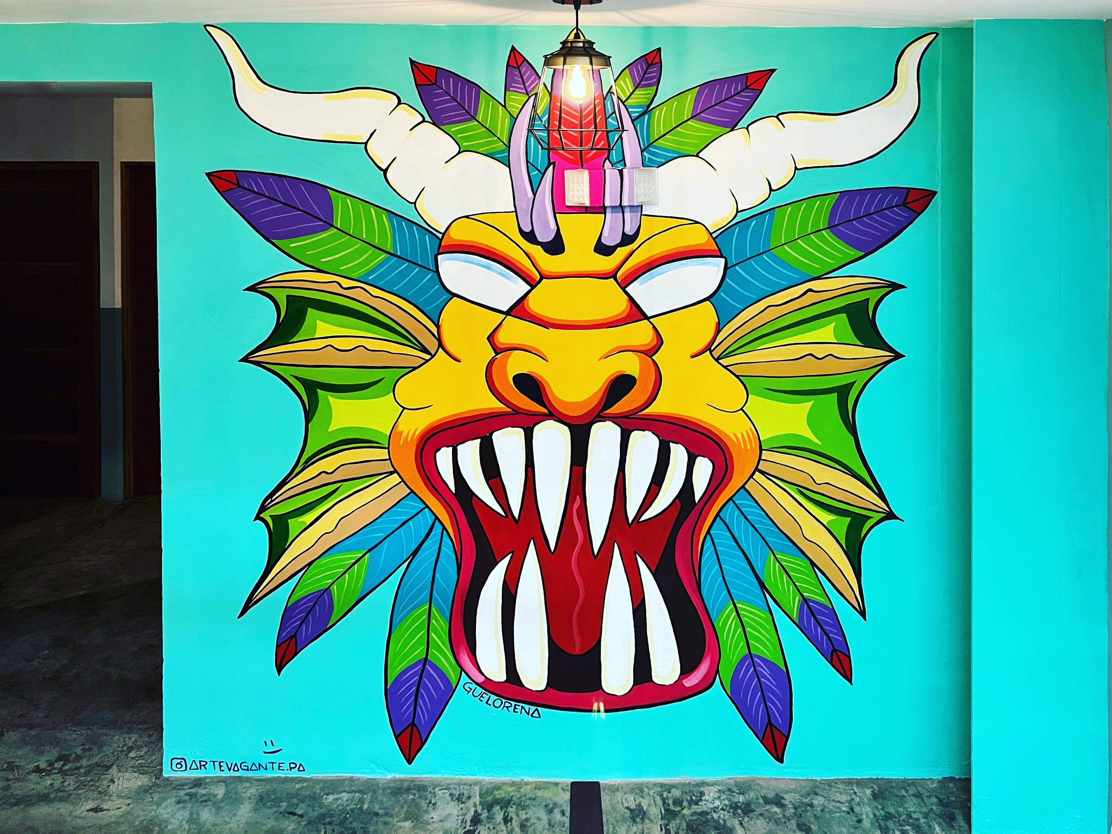 A vibrant mural of a mythical creature with a lantern above its head, set against a teal background.