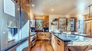 Una cocina moderna con armarios de madera, electrodomésticos de acero inoxidable y una isla grande.