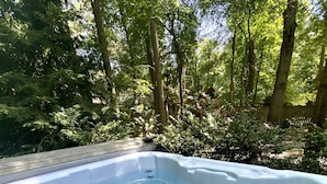A hot tub in a forested area with trees and greenery around. - Luxury Guesthouse in private wooded setting in Grand Beach New Buffalo (New Buffalo)