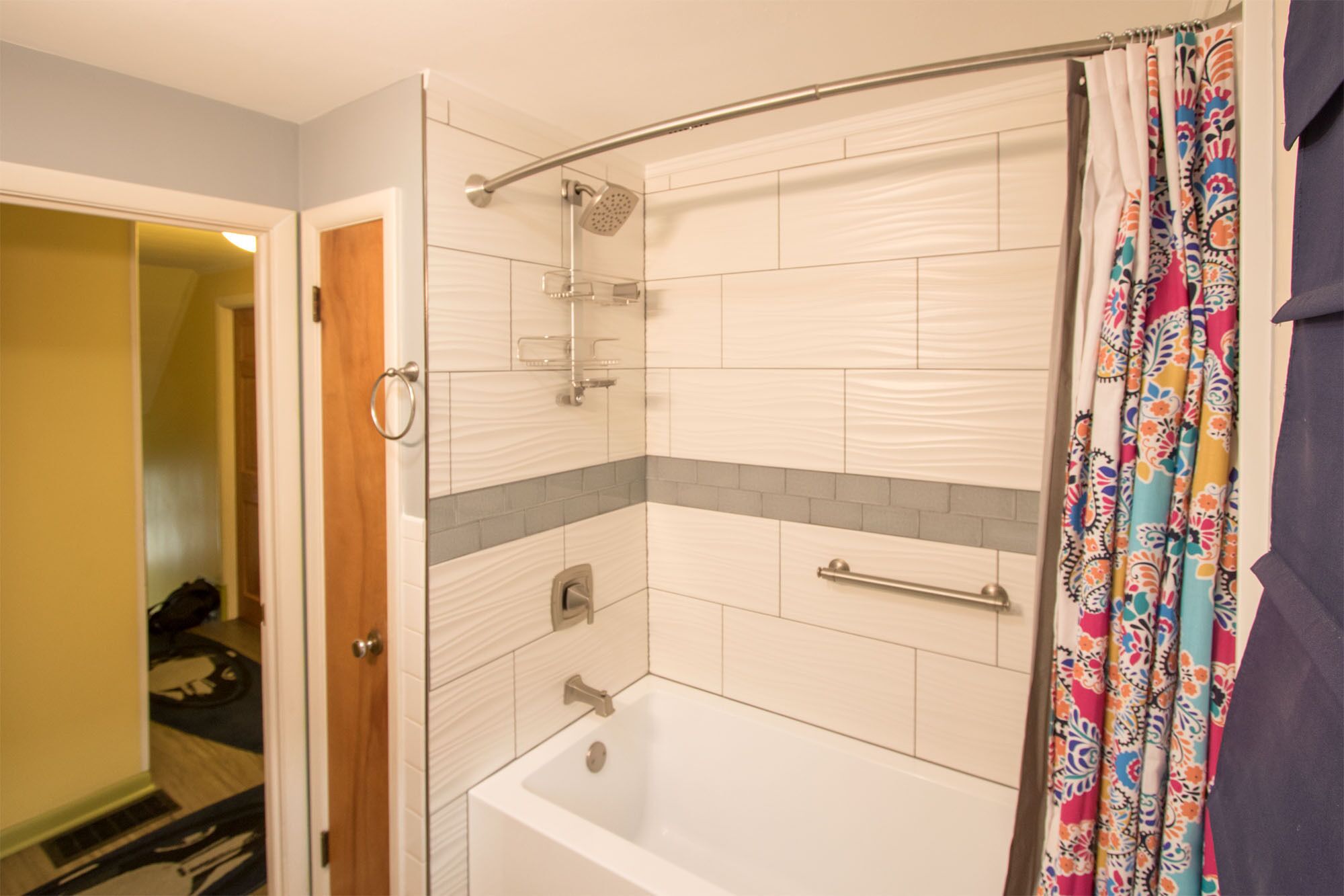 A bathroom with a shower, a bathtub, and a toilet.