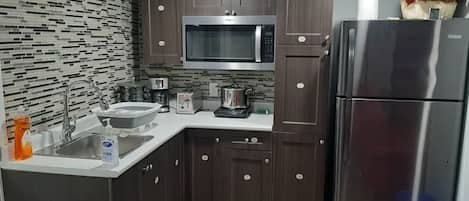 Fridge, microwave, stovetop, coffee/tea maker