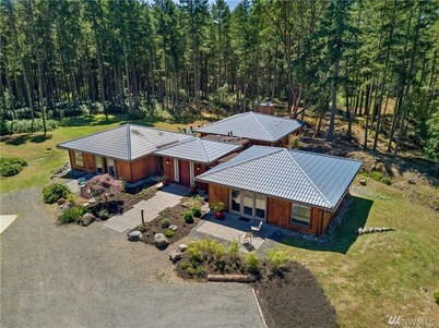 Luxury four bedroom home on sixteen acres of wooded privacy.