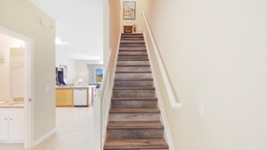 A staircase with wooden steps leading to a landing.