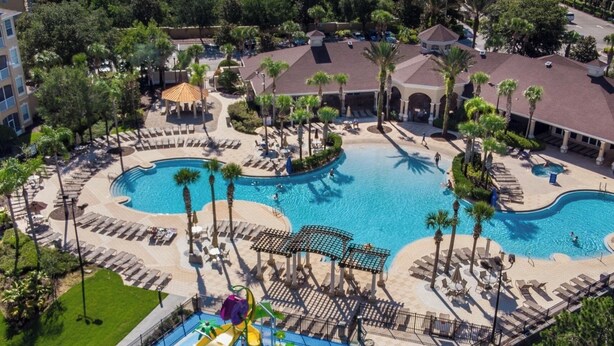 A resort with multiple swimming pools, a water park, and lounge areas.