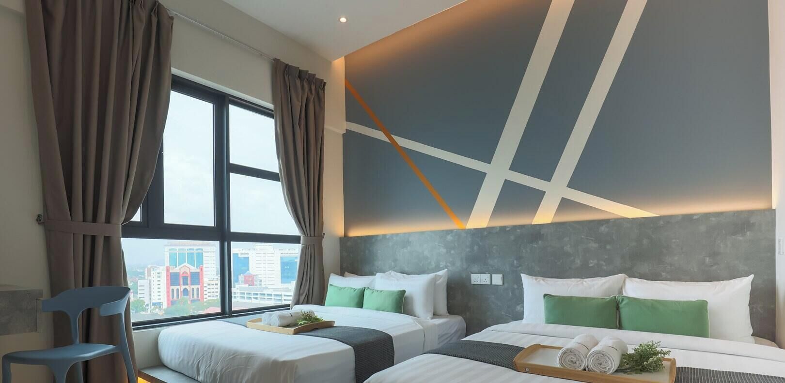 A hotel room with two beds, a view of the city, and a modern design.