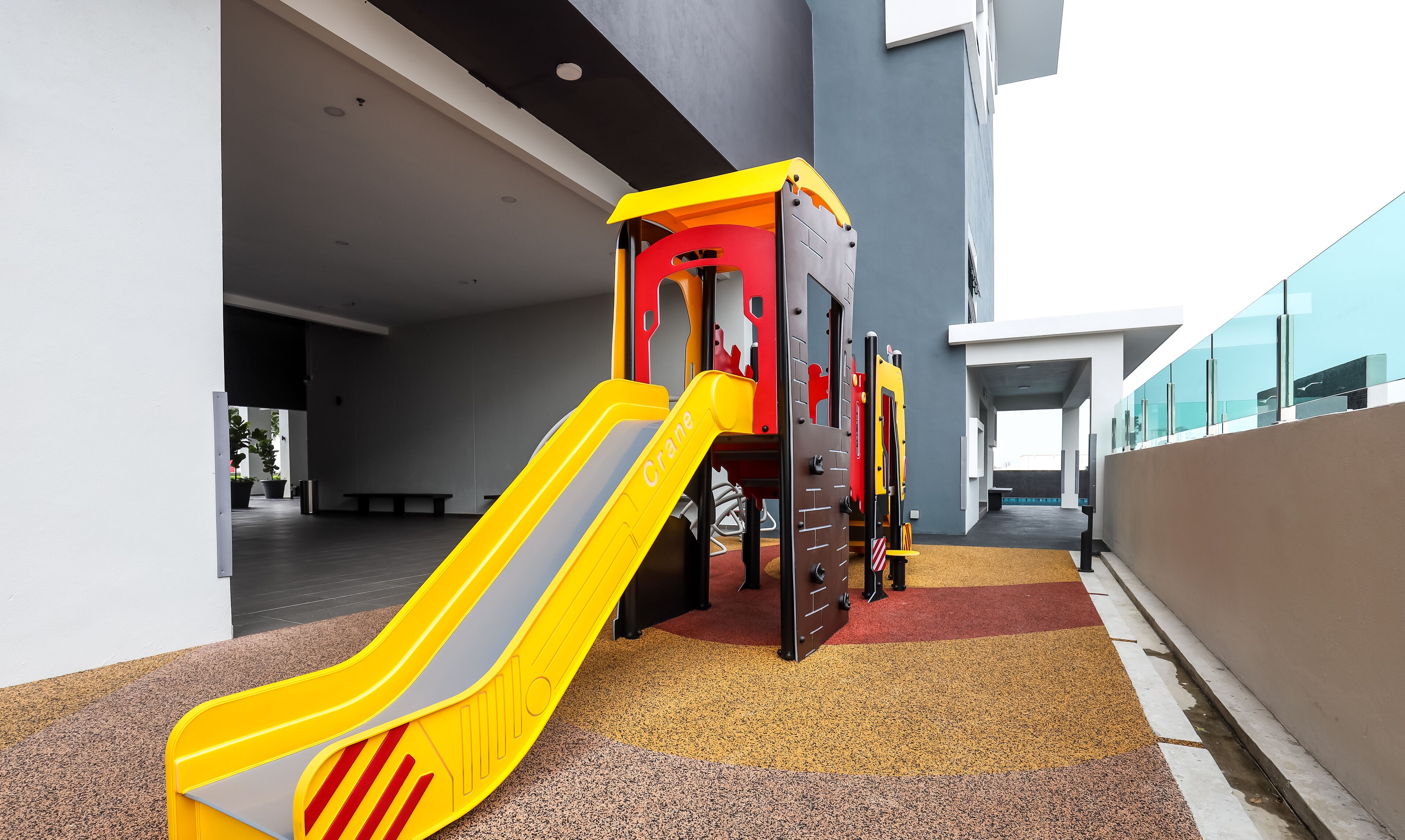 A children's play area with a yellow slide and climbing structures.