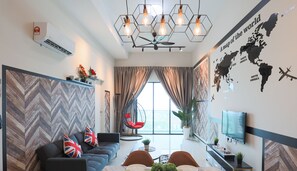 A modern living room with a sofa, dining table, and chairs, a world map on the wall, and a ceiling fan. - Ong Kim Wee Residence Melaka By I Housing (Malacca City)