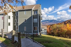 A multi-story building with a flat roof and a staircase leading to the entrance. - Sweeping Views Of GSMNP/Indoor Pool & Hot Tub (Gatlinburg)