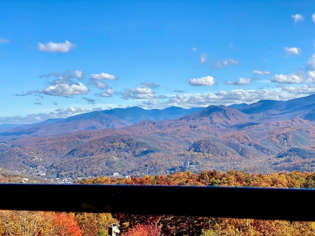 A panoramic view of a mountainous landscape with a town in the valley.