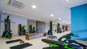 A modern gym with various exercise equipment, a bench, and a trampoline. - Enjoy Olimpia Park Resort (SP)