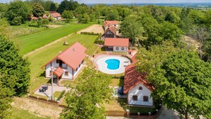 A large house with a swimming pool, surrounded by a well-maintained garden and multiple smaller buildings. - Nice home in Rivalno with sauna (Rivalno)